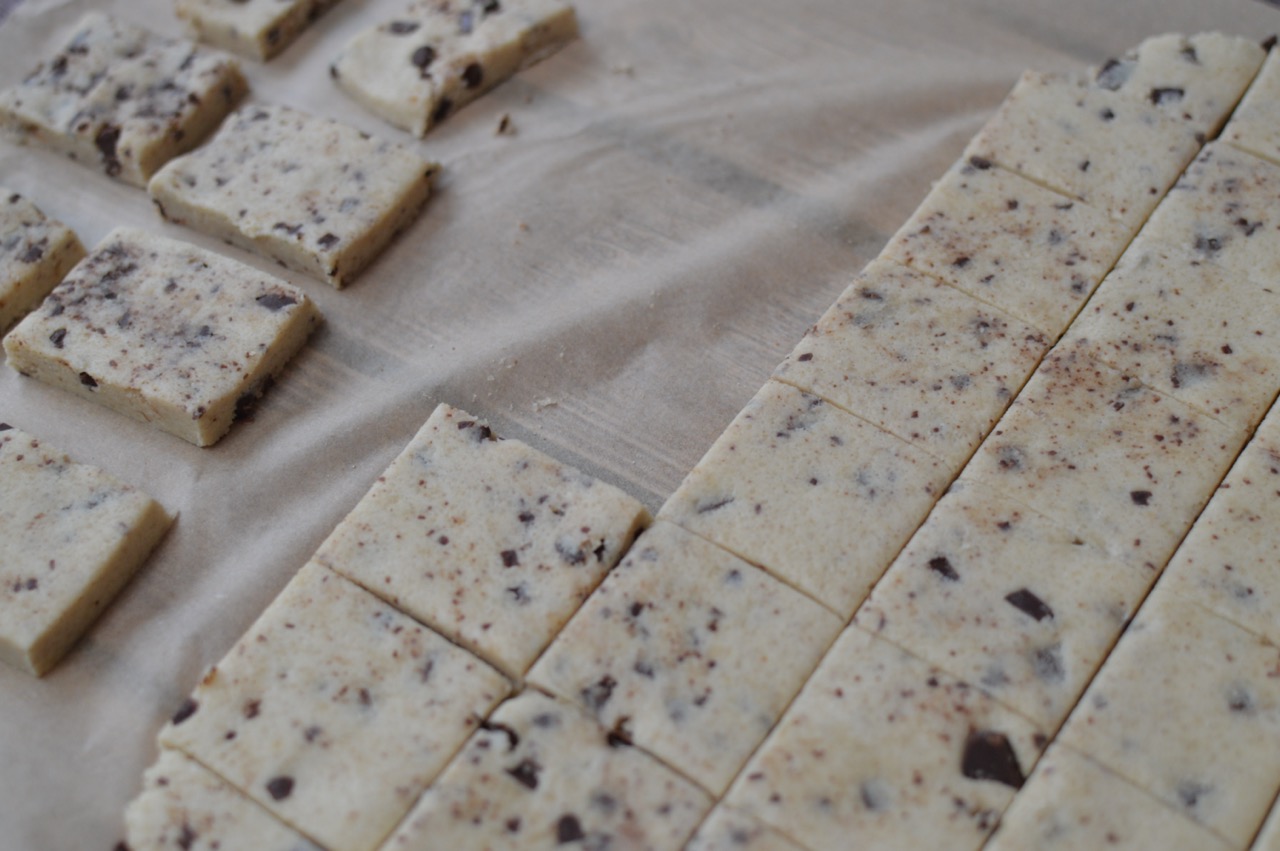 Image of cookie dough cut into squares and laid out on baking parchment